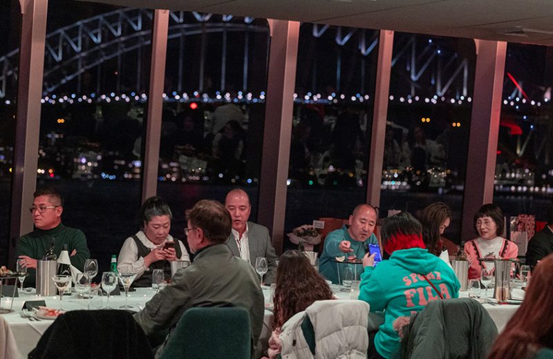 Guests dining on the Clearview with a view of the Harbour Bridge behind them