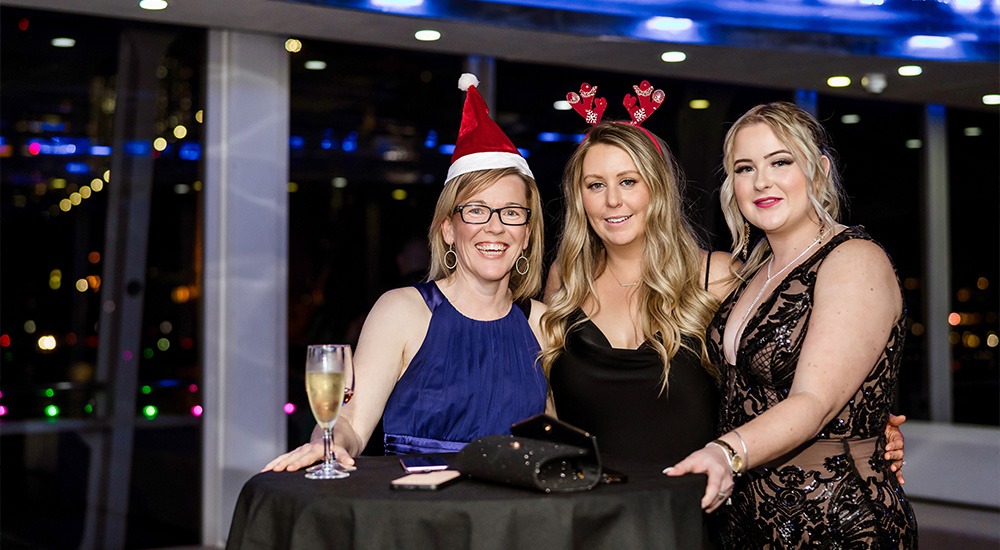 Colleagues celebrating Chirstmas party on dinner cruise
