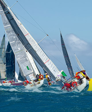 Participant yachts of the Sydney Hobart Yacht Race photographed on Sydney Harbour from the Clearview Glass Boat cruise